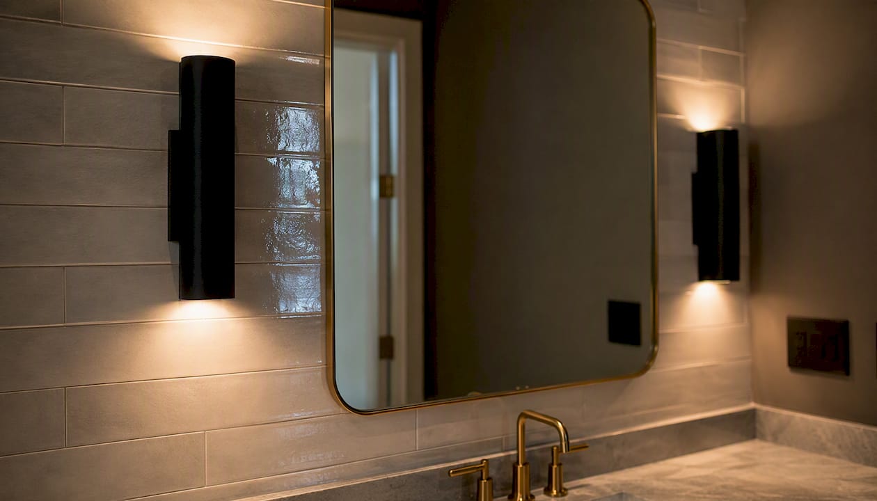 Powder room mirror lighting minimizing glare on tiles