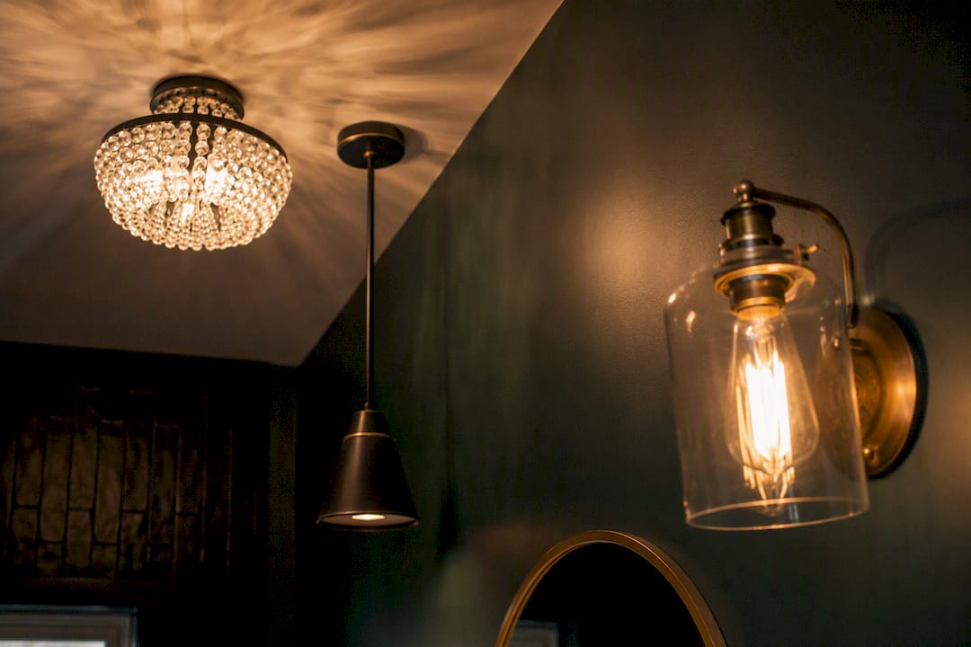 Small powder room interior featuring mixed lighting styles