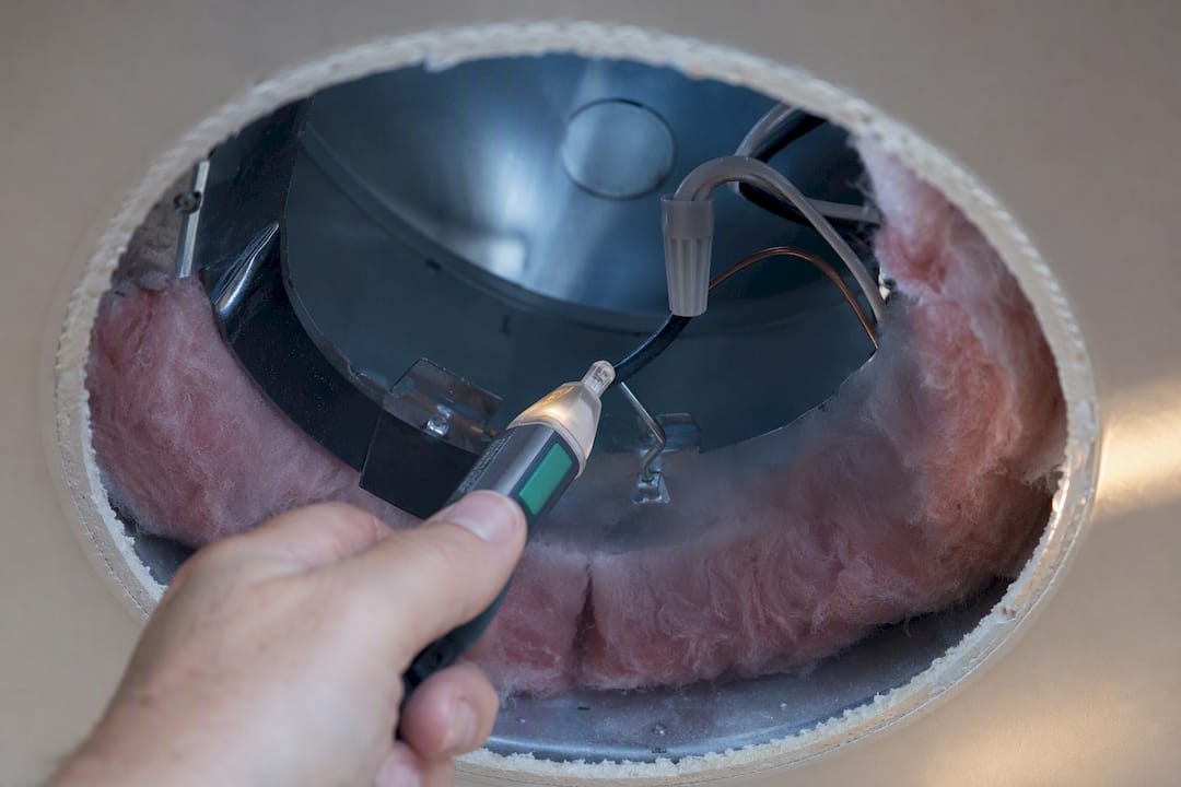 Voltage tester checking recessed housing safety