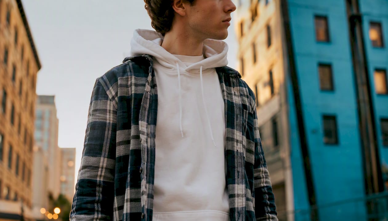 Layered white hoodie and navy plaid flannel detail
