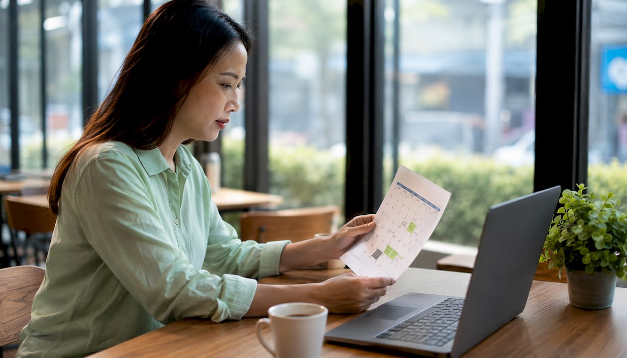 Hands holding calendar with payroll deadlines