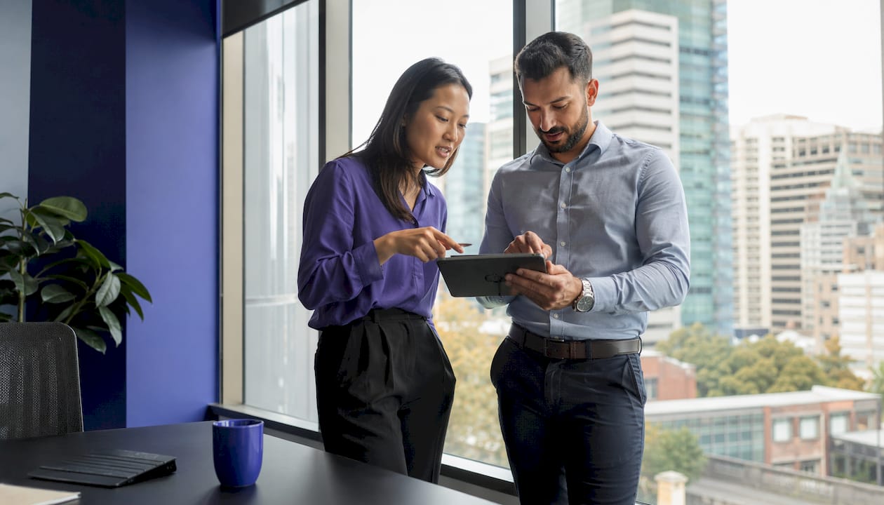 Two marketers discussing agency choices in office