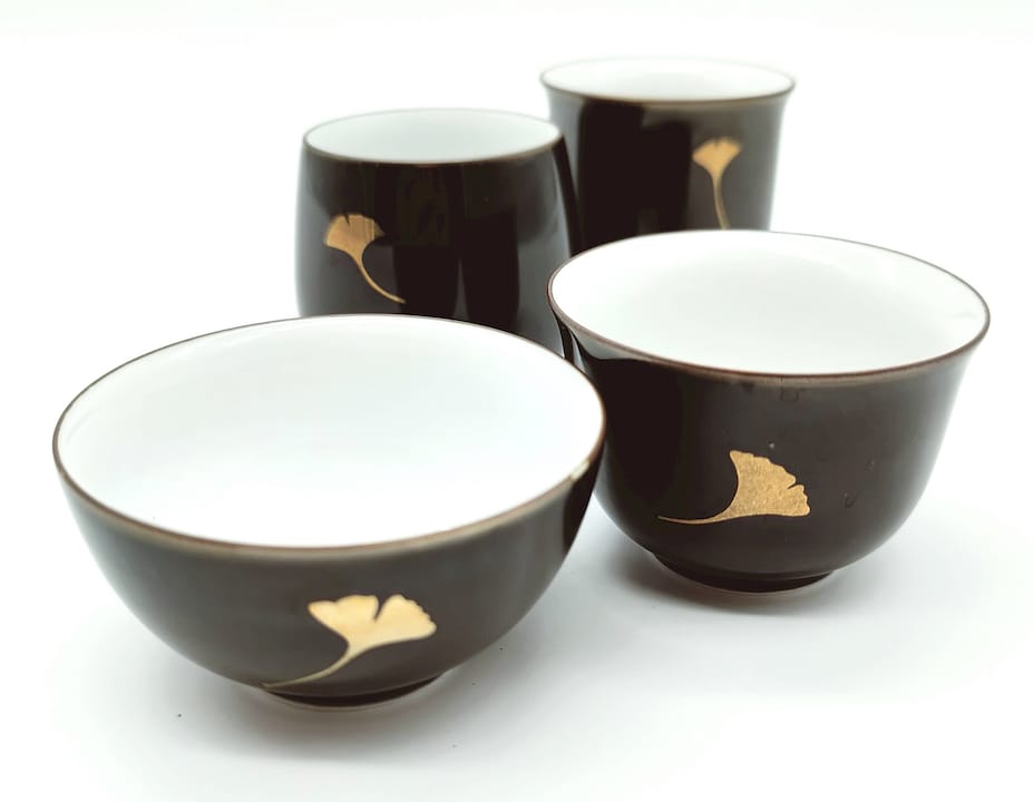 Potter applying metallic overglaze to fired porcelain