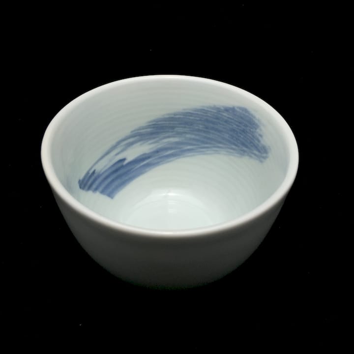 Glazed bowl glowing under warm low lamp light