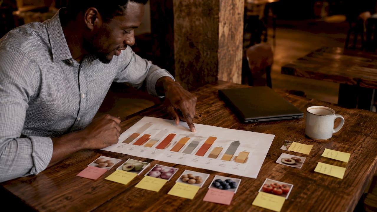 Close-up of hands pointing at market analysis chart