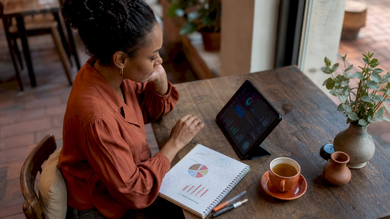 Data analyst reviewing multiple dashboards in office