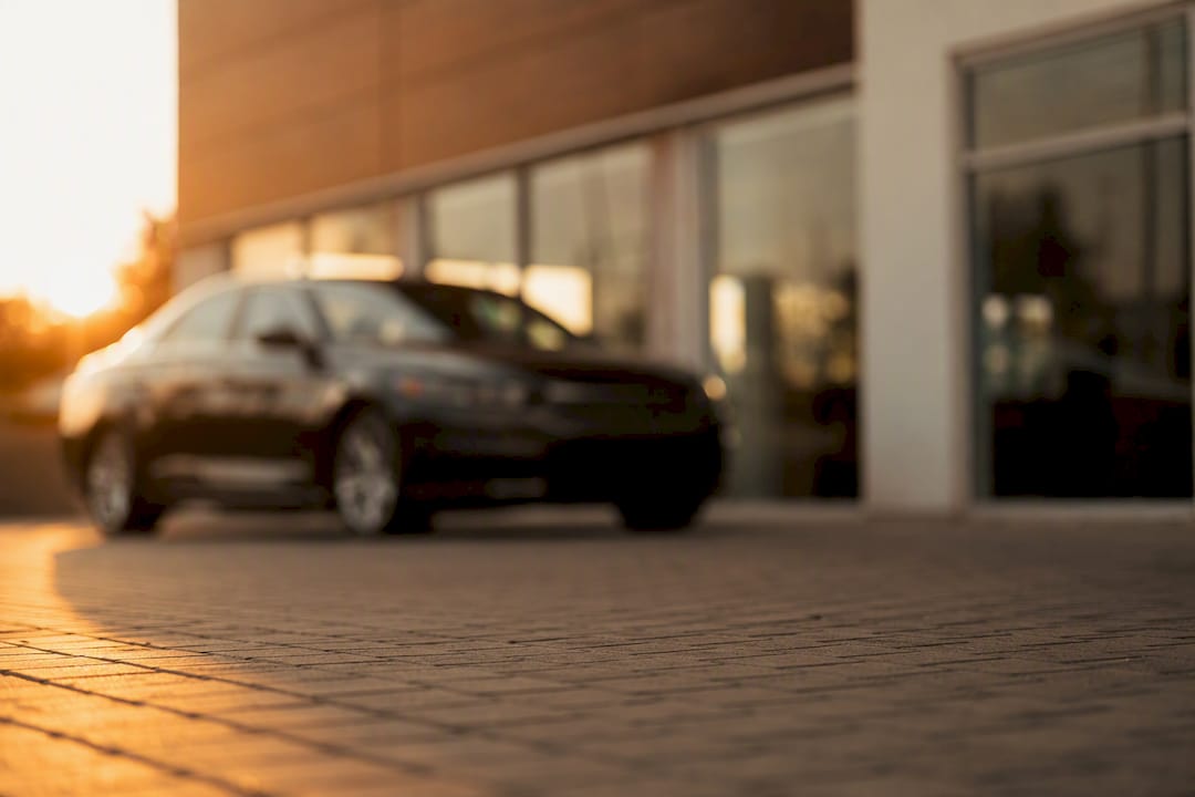 Silhouetted car at dealership on cloudy day