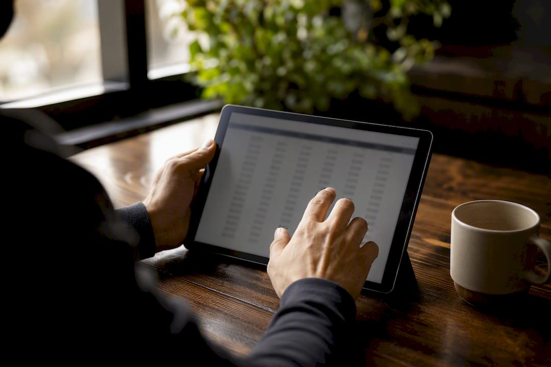 Hands browsing loan amortization on tablet
