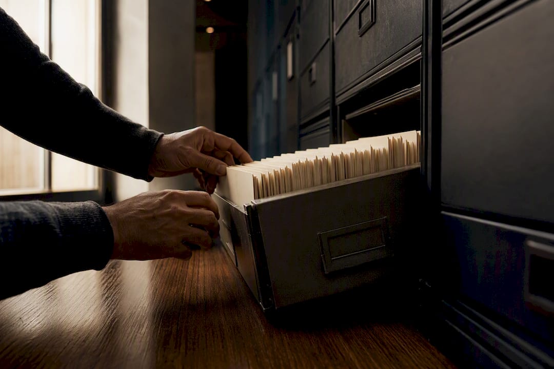 Archival folders representing historical loan records