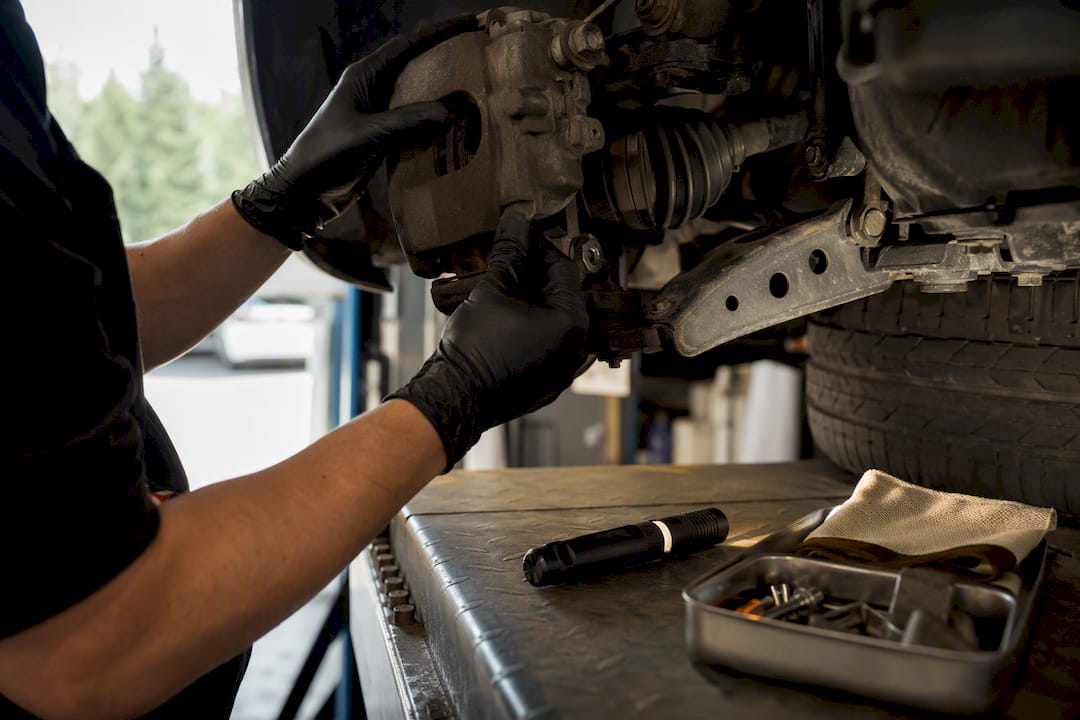 Mechanic inspecting used car brake