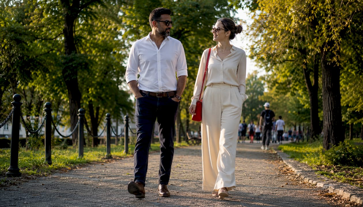 Man and woman in smart casual outfits at café table