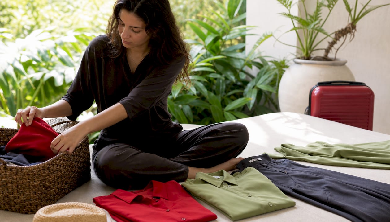 Hands sorting wrinkle-resistant travel clothes
