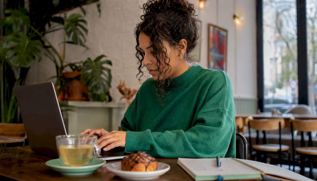 Woman entering discount code during online checkout