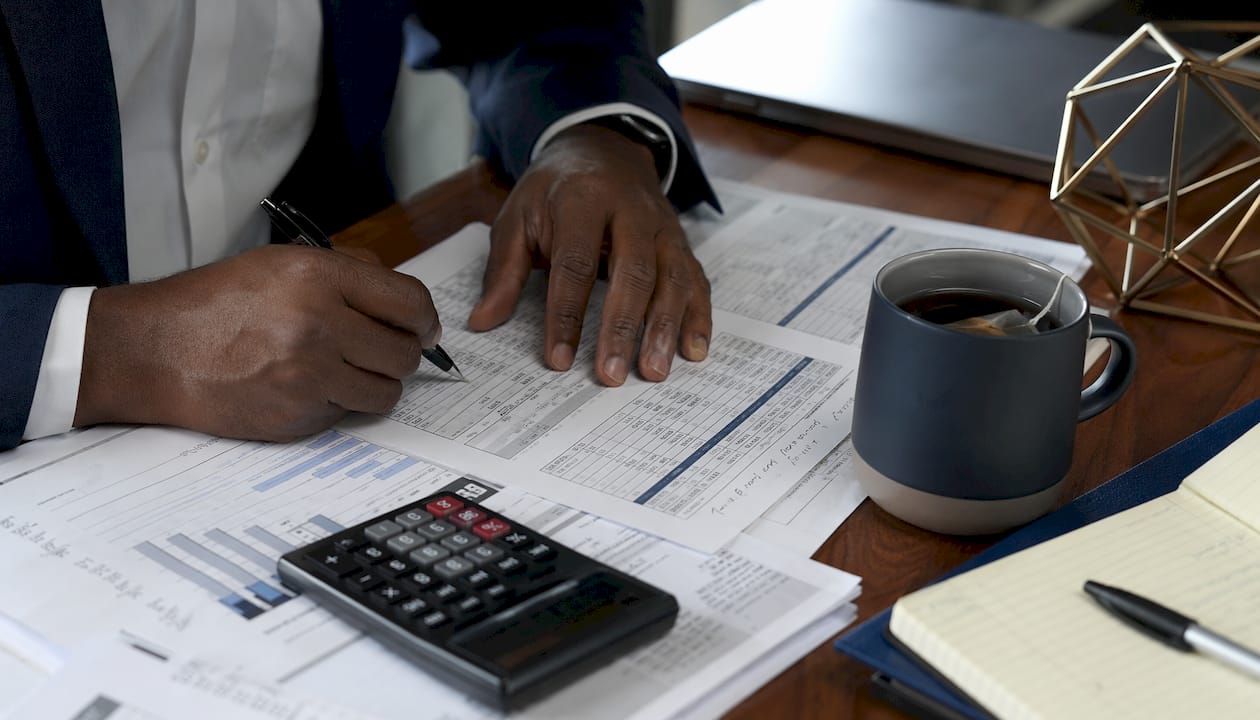 Overhead view of DSCR calculation documents and hands