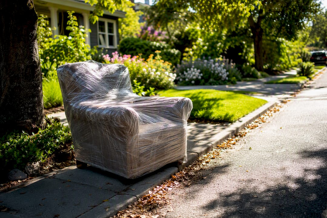 Wrapped furniture marked for curbside bulky pickup