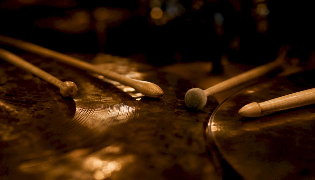 Close-up of drumstick tips on cymbals