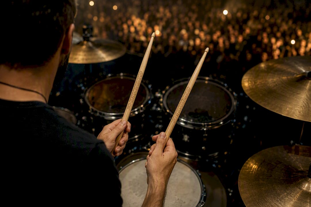 Drummer holding personalized engraved drumsticks on stage