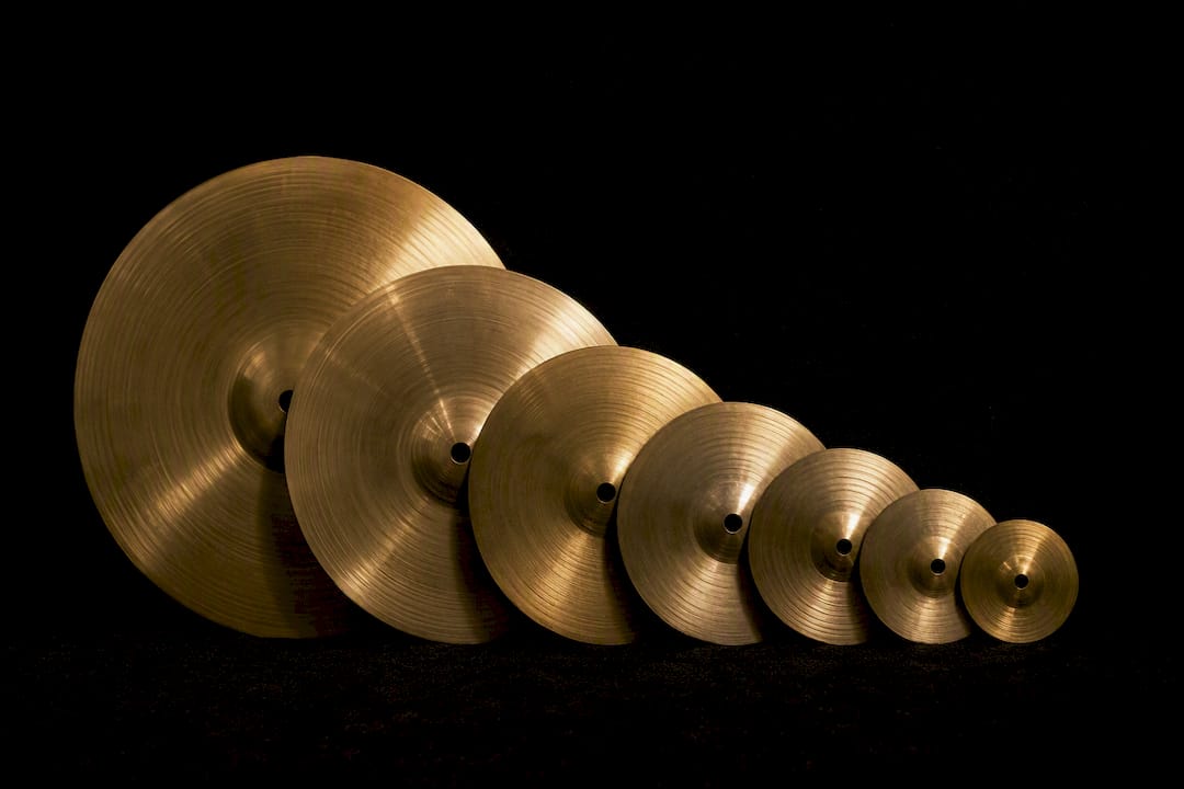 Splash cymbals of various sizes on black surface