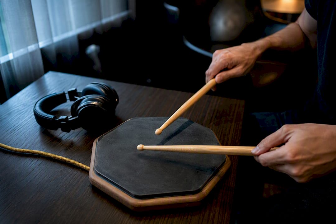 Hands practising rudiments on drum pad