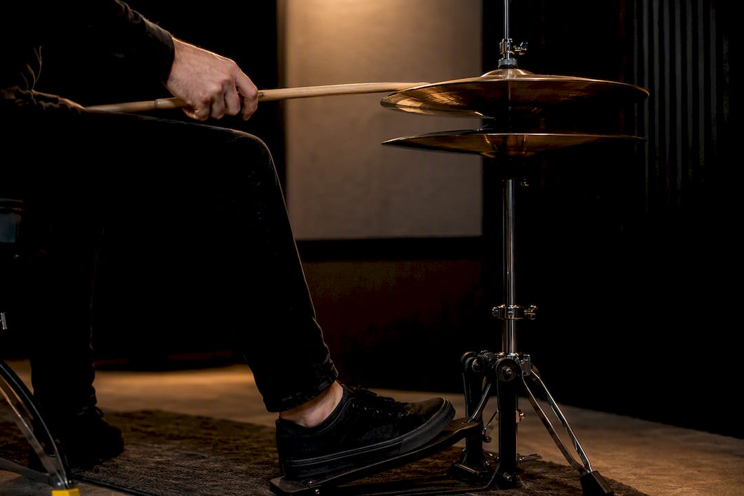 Drummer controlling partially visible hi-hats
