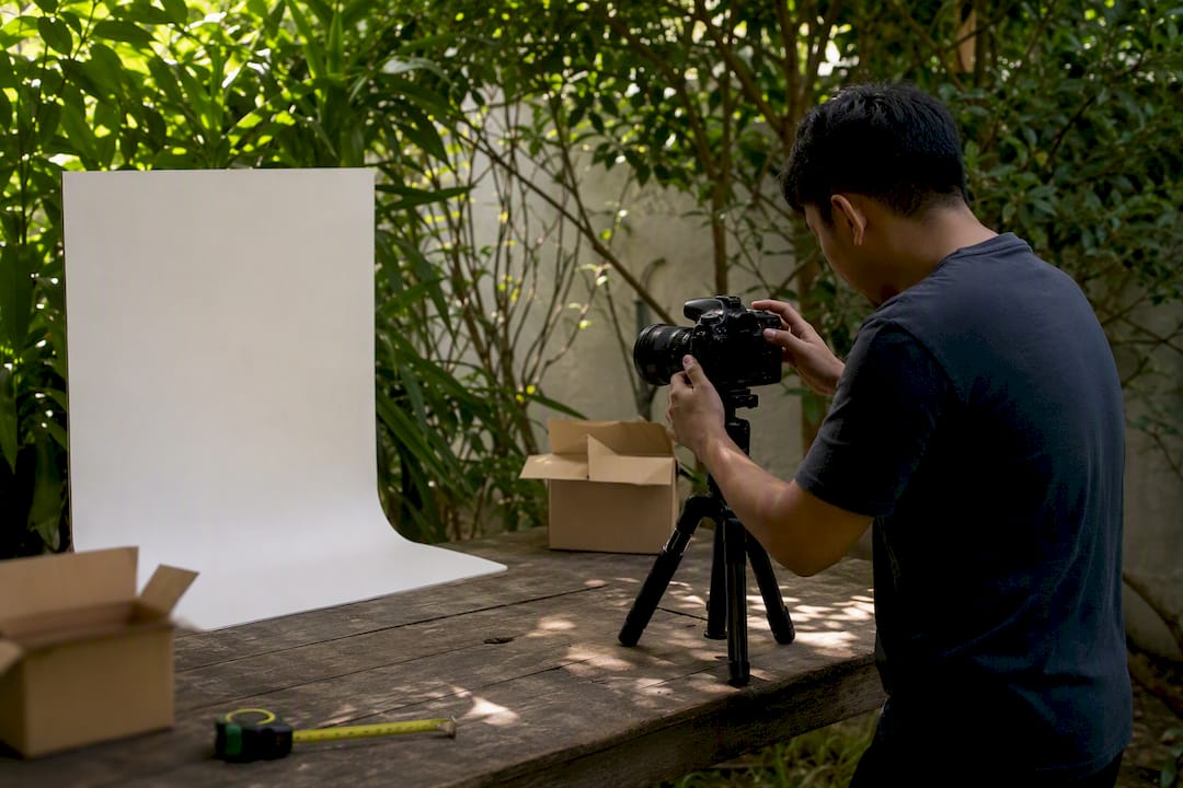Hands adjusting camera for product photos