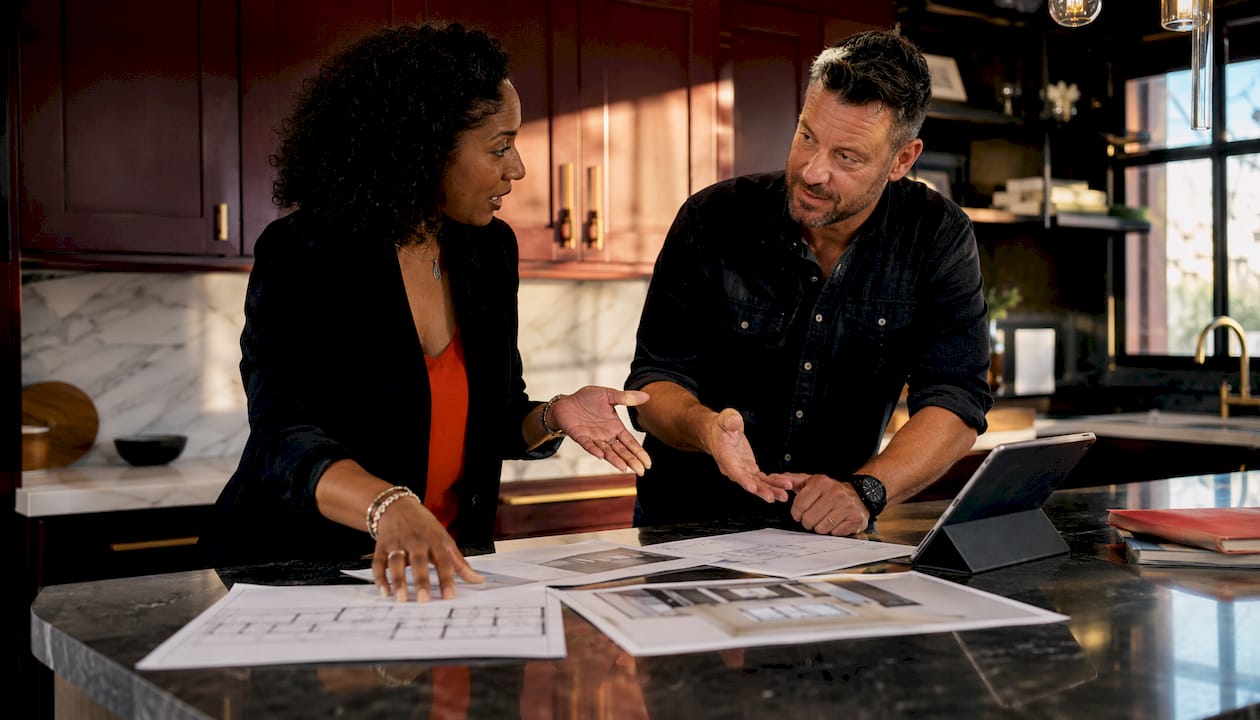 Project manager and contractor discussing bathroom renovation costs
