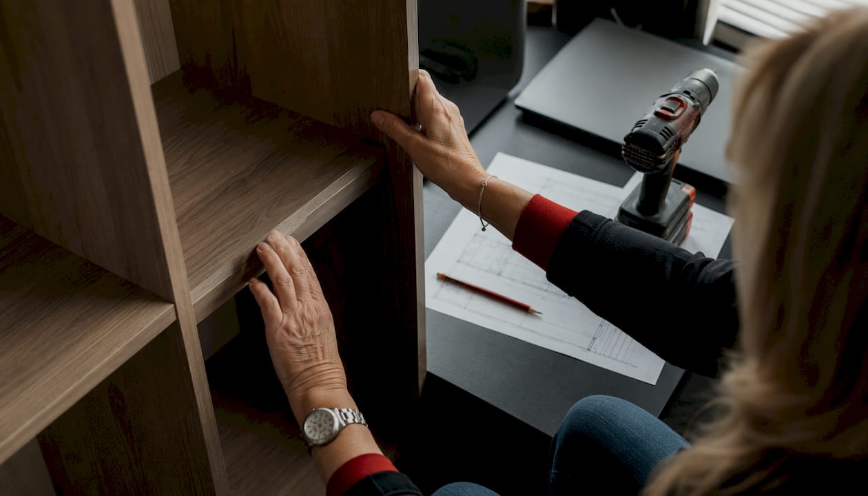 Carpenter measuring built-in shelving details