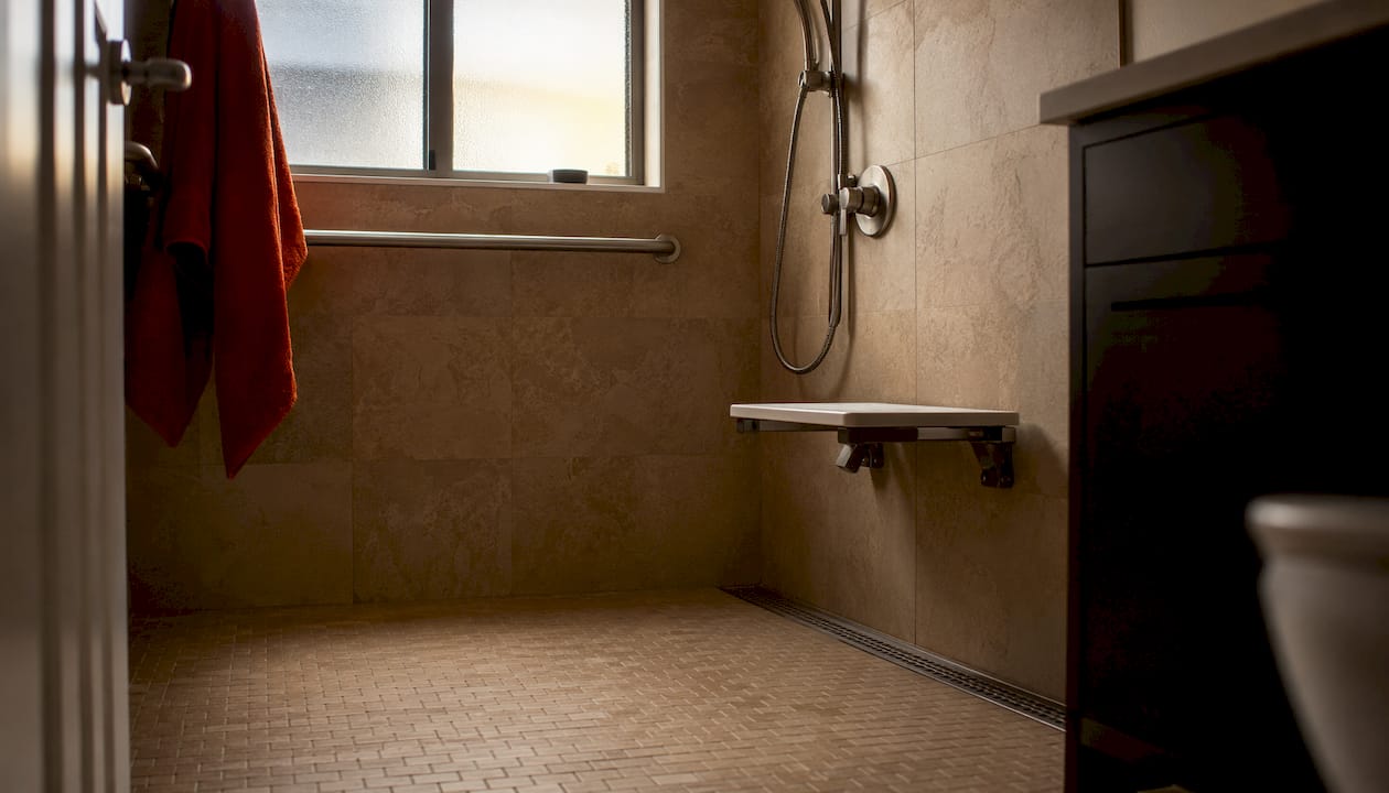 Curbless shower with seat and handheld showerhead