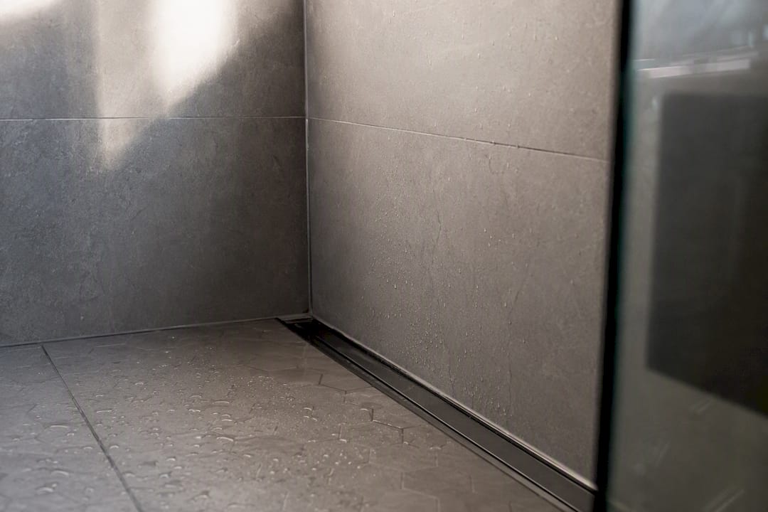 Close-up of tiled walk-in shower corner