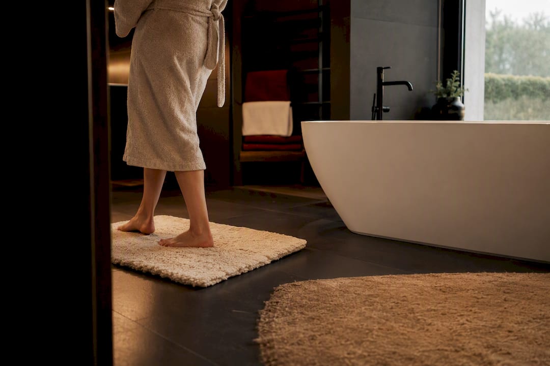 Bare feet on warm bathroom floor