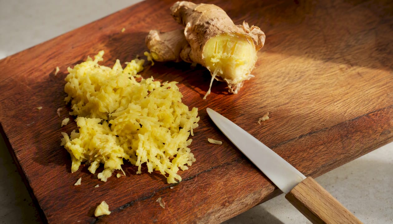 Fresh grated ginger on wooden board