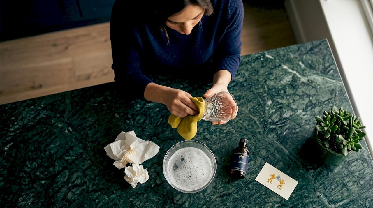 Person polishing scratched crystal glass