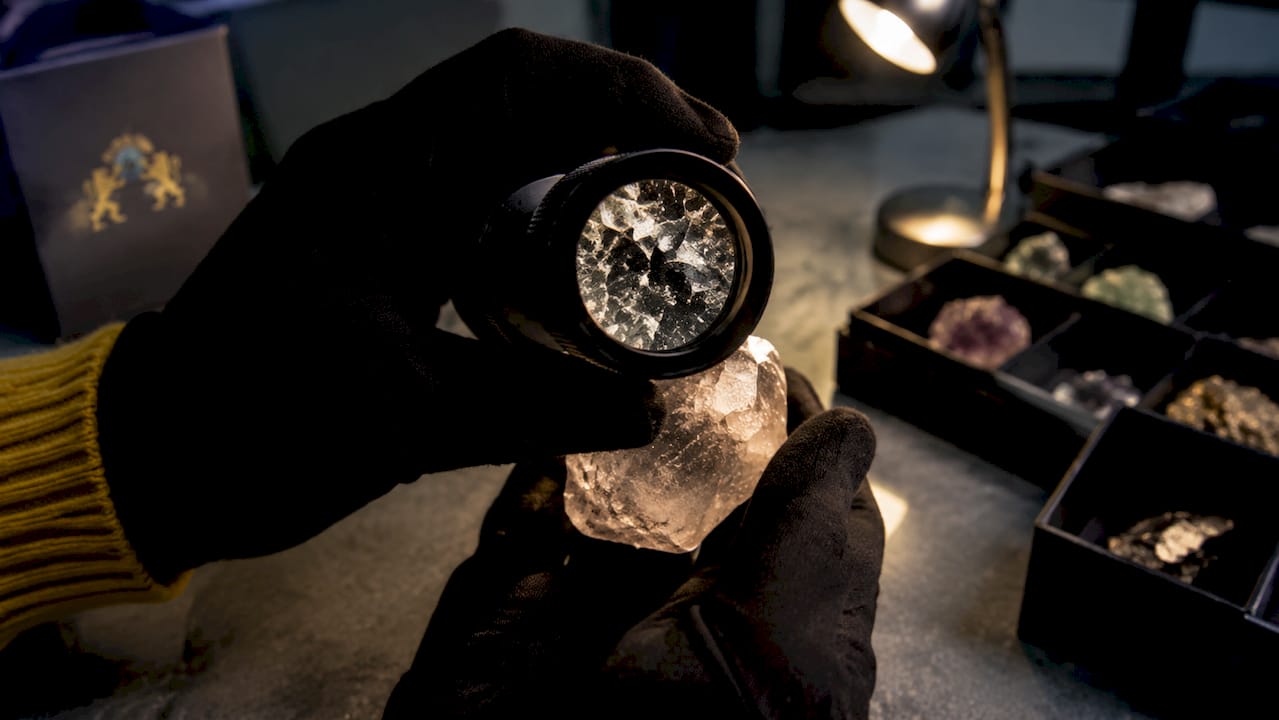 Close-up of crystal under jeweler's loupe showing inclusions