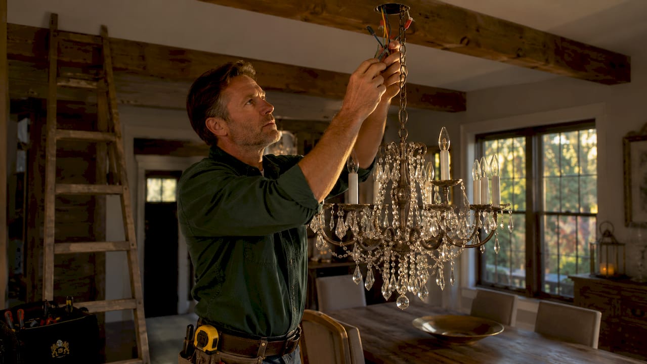 Electrician wiring chandelier junction box