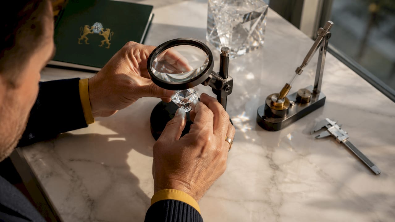 Jeweler adjusting cut crystal facets