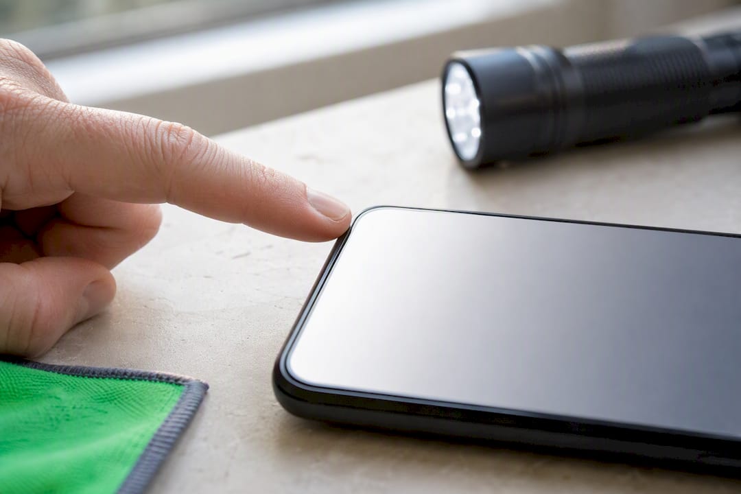 Fingertip testing a used phone screen