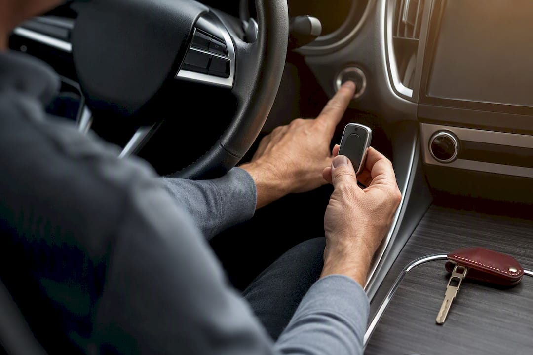 Hands pairing proximity fob with start button