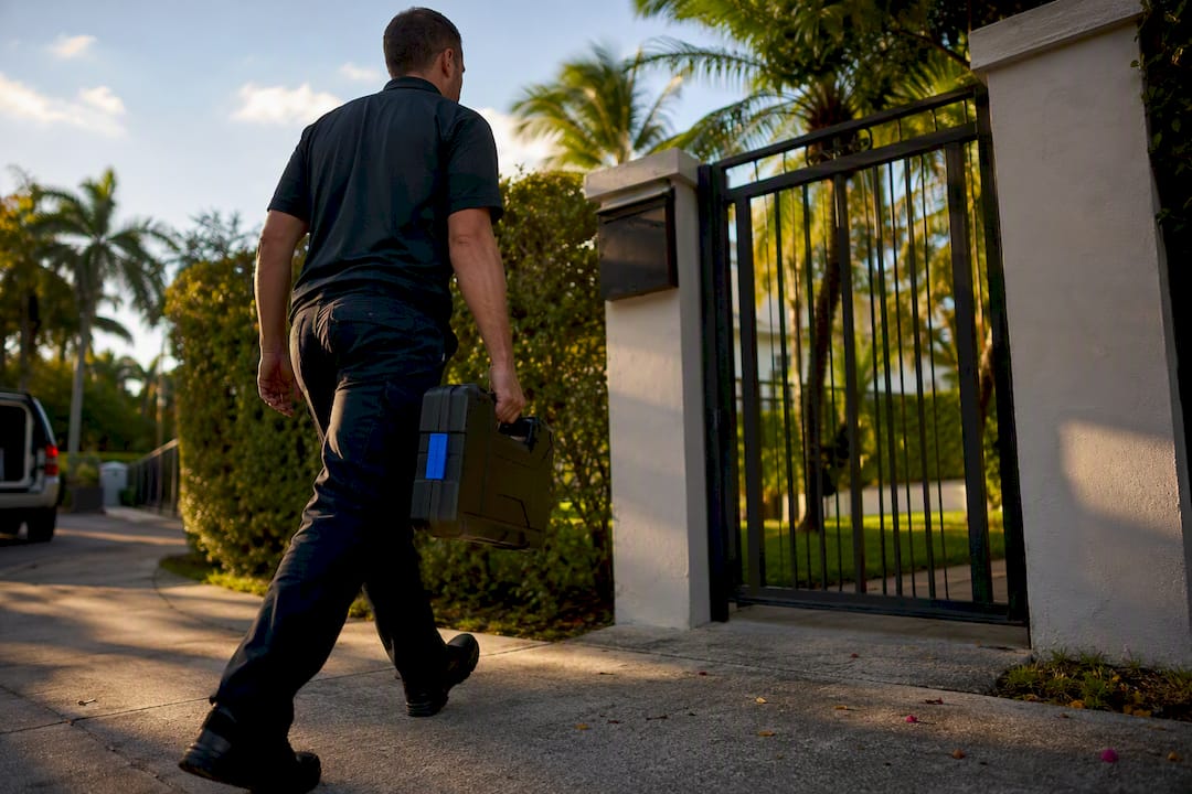 Locksmith technician arriving at residential gate