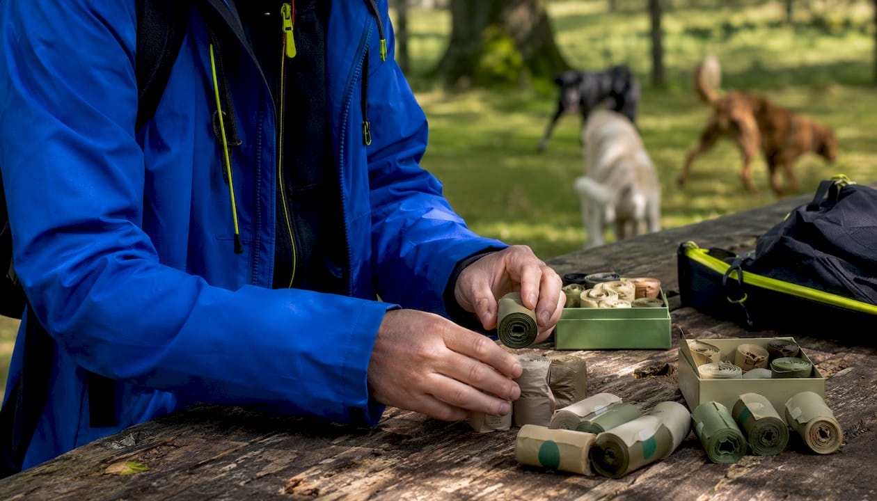 Hands inspecting compostable dog poop bags in store