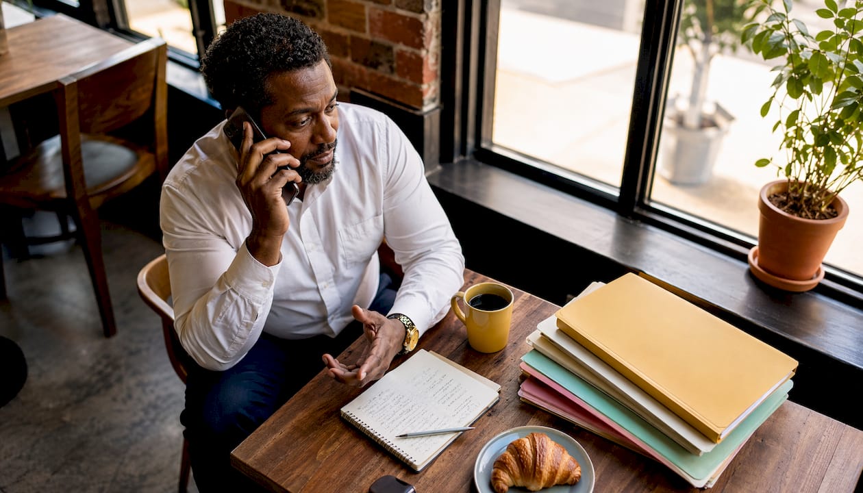 Business owner talking on phone about factoring