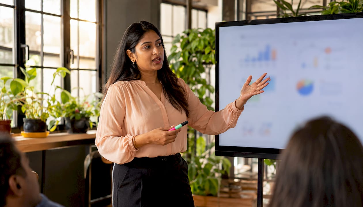 Businesswoman explaining loan interest accrual on whiteboard