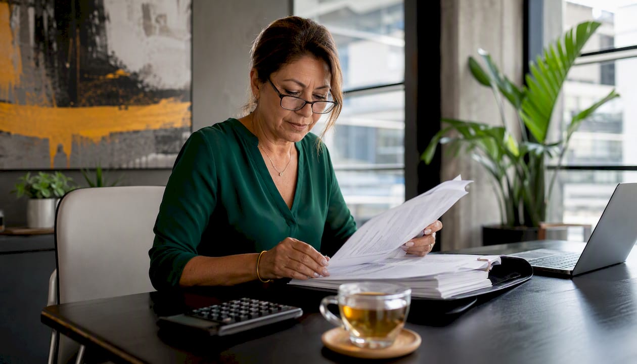 Business owner reviewing invoices at desk