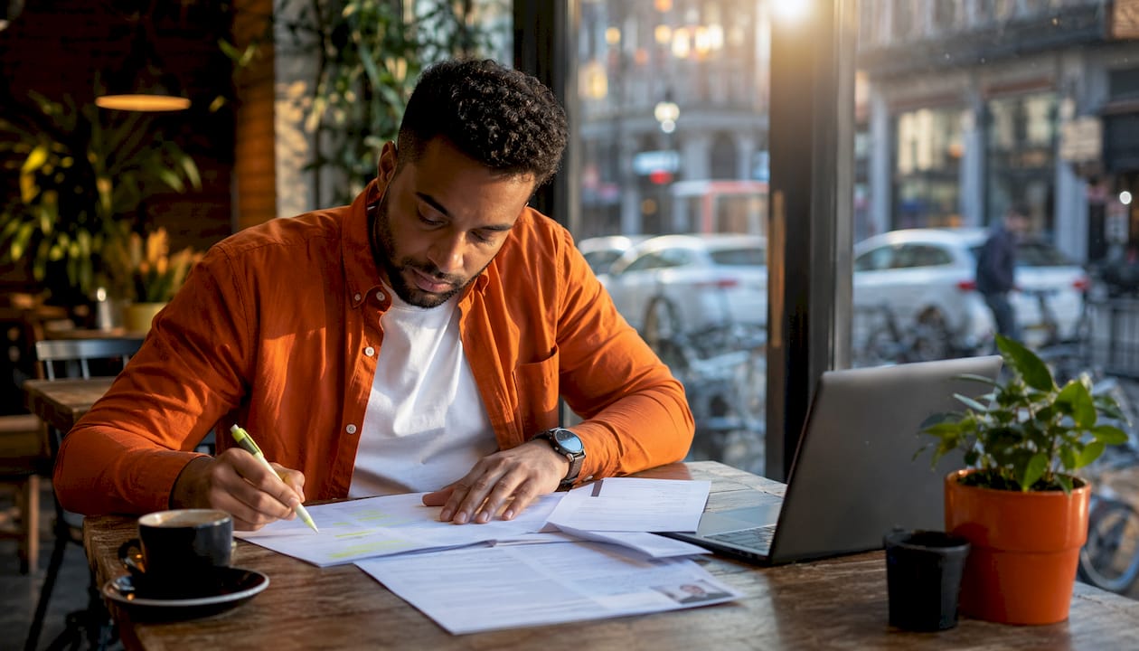 Hands arranging resume skills pages on table
