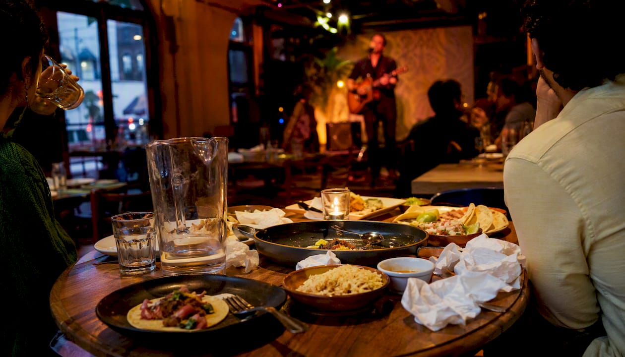 Latin dinner table with live music stage in background
