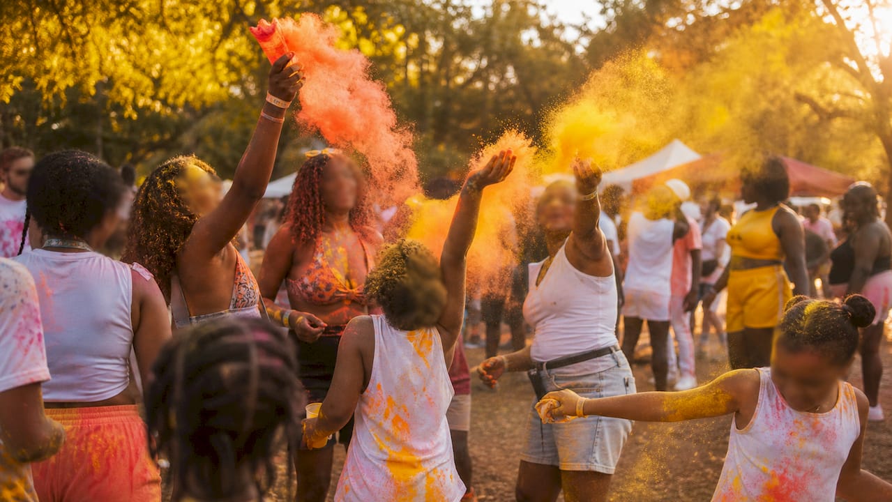 Festival-goers throwing colorful powder paint