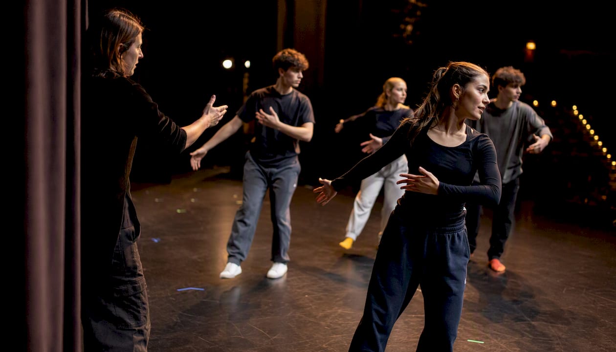Teen performers rehearsing on stage