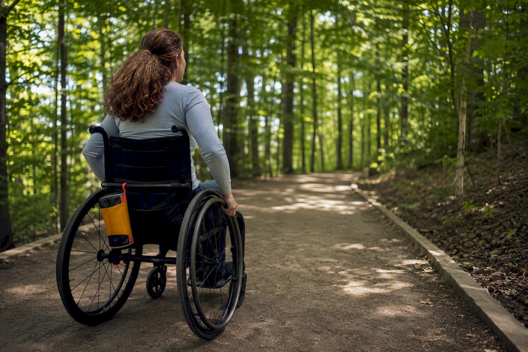 Wheelchair user on accessible forest trail