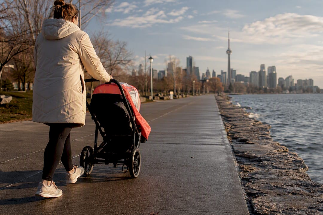 Parent pushing stroller along Toronto waterfront trail