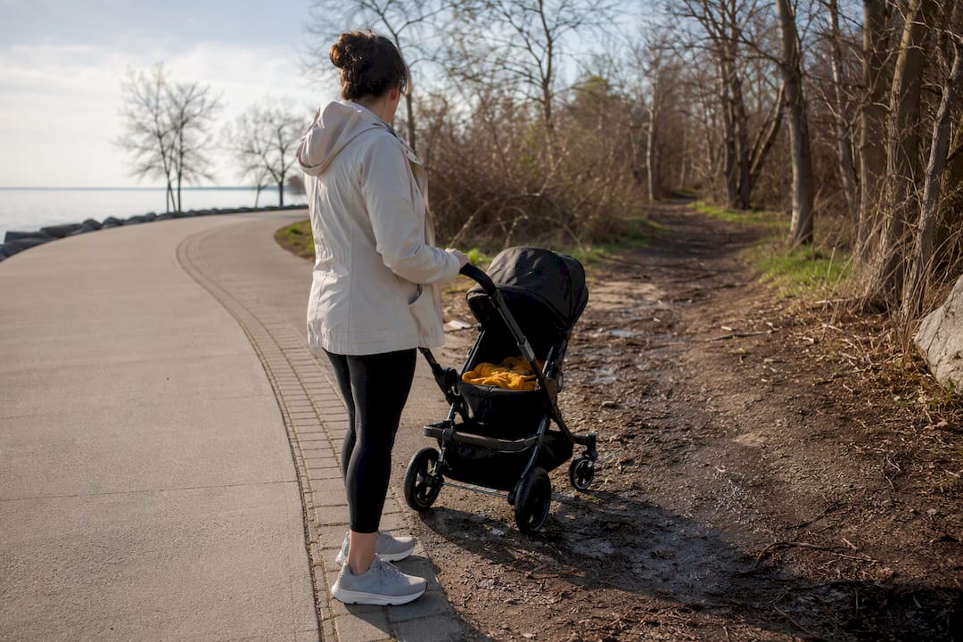 Stroller at paved and muddy trail transition