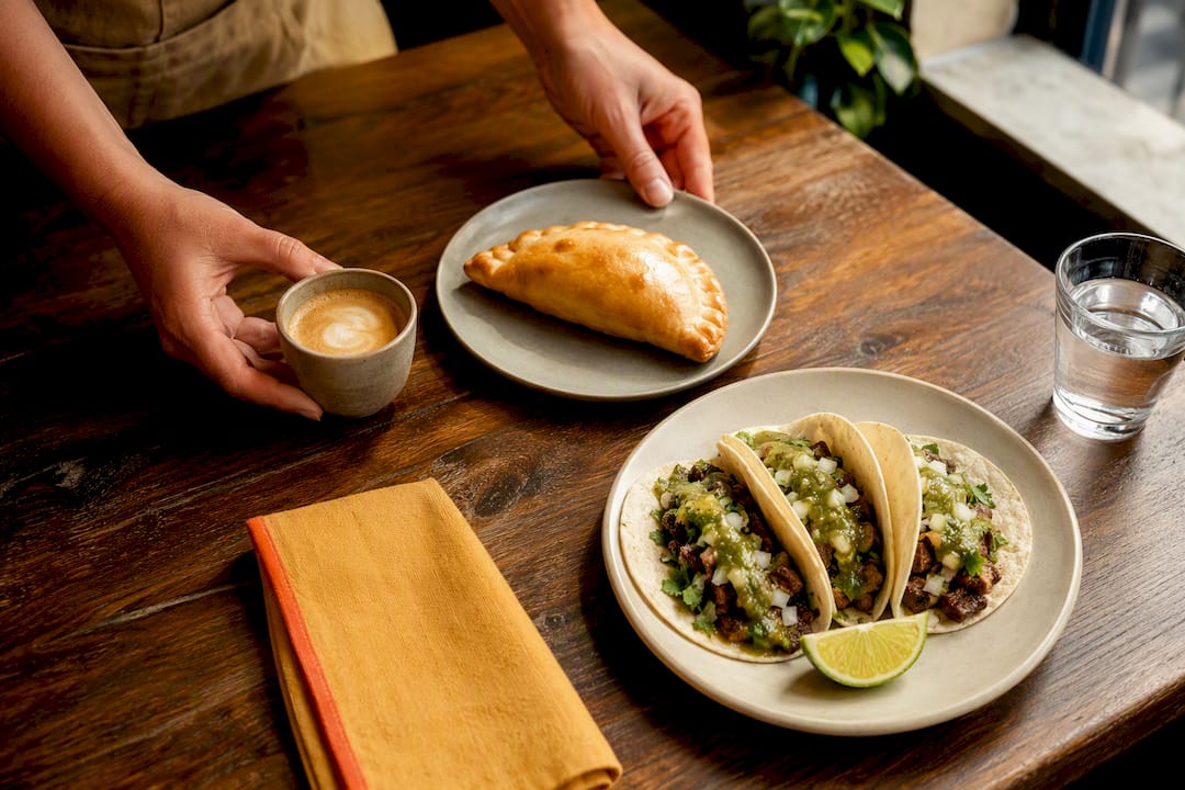 Coffee empanada and tacos on cafe counter